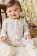 Barboteuse en coton biologique et élasthanne à motif floral délicat et neutre, avec fermeture éclair avant sur toute la longueur, pour le quotidien de bébé (0-3 ans)